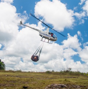 The helicopter leaves Ruddi Kappel airstrip with a sling full of cargo for the summit camp