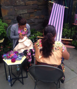 Juana and Maria in action! Yolanda weaves with the back strap loom while Juana embroiders.