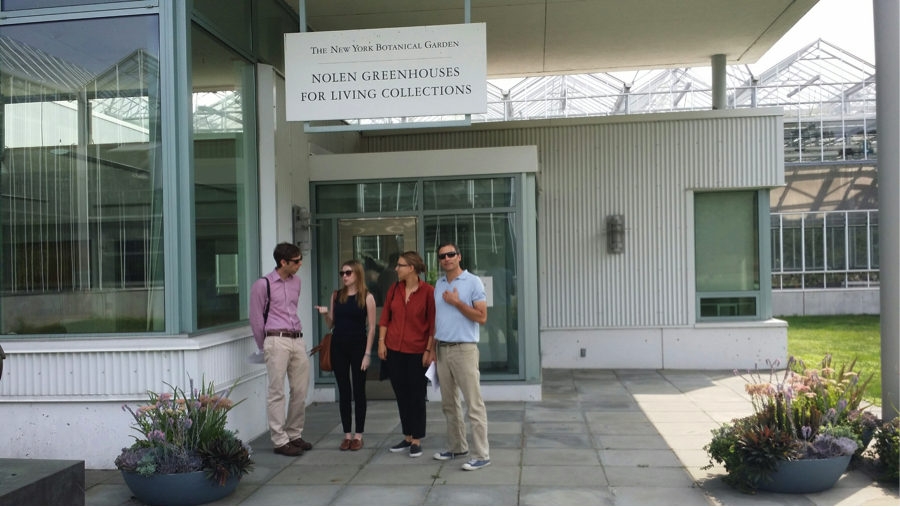 Humanities Fellows Ryan Feigenbaum, Elaine Ayers, Claire Sabel, and Theodore Eisenman at the entrance to the Nolen Greenhouses for Living Collections