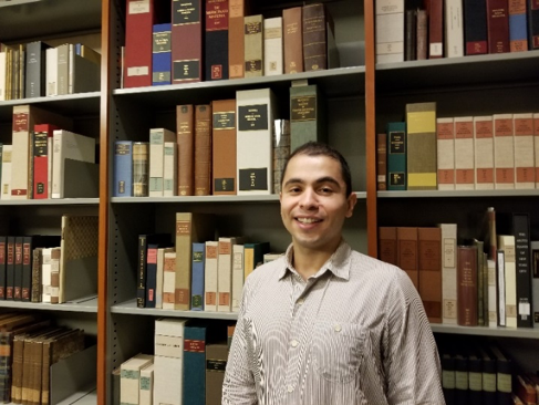 Andres Orejuela standing in front of his favored medieval works