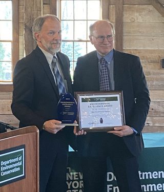 Photo of Dr. Brian Boom receiving his recognition