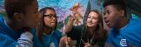 STEM Students looking at a leaf in the Green School