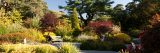 A woman sitting on a bench in the Perennial Garden