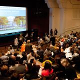 A crowd viewing a presentation in Ross Hall.