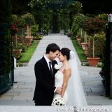 Bride and Groom taking a photo in the rose garden