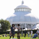 Two visitors enjoy an event outside the Enid A. Haupt Conservatory.