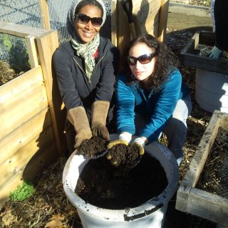 Volunteers showing off clean soil for gardening.