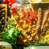 An arrangement of foods on a cutting board in the sun