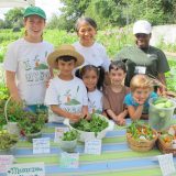 Children and NYBG staff celebrating their crop harvest.