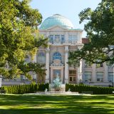 Library Building with green grass. Mertz Library, Fountain of Life