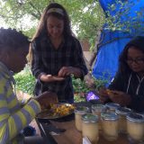 Bronx Green Up staff sorting seeds in a Community Garden.