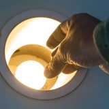 Image of changing an energy efficient lightbulb.