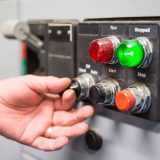 Image of a hand turning on switches