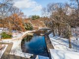 An aerial view of the Native Plant Garden in winter, with snow all around.