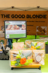 A farm stand offering baked goods and vegetables