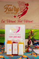 A farm stand offering bottled fruit juices