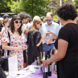 People sample wine during a sunny outdoor festival