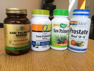 Four plastic containers of supplements