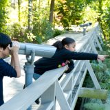 Kids looking through telescope at Adventure Garden