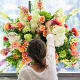 A design student creates a flower arrangement.