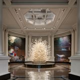 The Palazzo Ducale Tower set between two large photographs of Dale Chihuly's art.