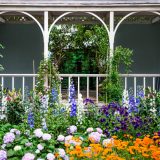 Gazing at the Impressionism display from the porch of a New Englad cottage in the Conservatory.