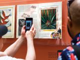 Visitor taking a picture of a display in the Georgia O'Keeffe: Visions of Hawai‘i exhibit