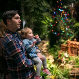 A father holding his child at the Holiday Train Show.