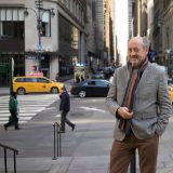 NYBG poet laureate Billy Collins standing on a busy New York City street.