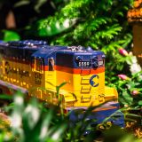 Photo of a model train surrounded by plants