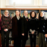 People standing in front of bookshelves