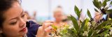 Woman participating in a floral arrangement activity