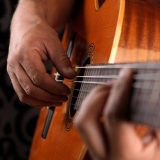 Musician playing slack key guitar