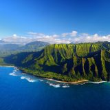 Aerial photo of an ocean and mountains in Hawaii