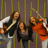 Funkytown Playground musicians posing with their guitars