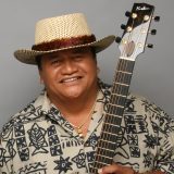 Led Kaapana posing with a guitar