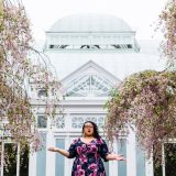 A woman in front of the Conservatory