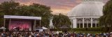 Guests listening to musicians perform with the Conservatory in the background