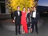 Four guests in from of a yellow sculpture at the Conservatory Ball