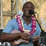 Musician playing a ukulele and singing