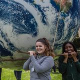 Volunteers carrying a giant Earth ball.