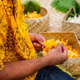 Artisan making a yellow flower lei