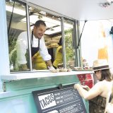 A woman ordering at a food truck