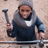 Photo of a child playing a wooden instrument