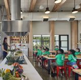 An NYBG staff member teaching children about gardening in the Edible Academy