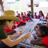 An NYBG employee teaching students about plants.