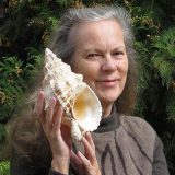 A headshot of Susan Hewitt with a gastropod shell