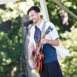Photo of a musician playing a guitar