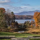 An autumnal scene overlooking a pond.