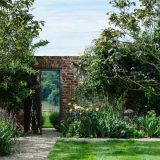 A brick gate amid lush flora.